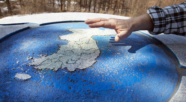Ben Torrey holds his hand over a map of the Korean Peninsula while explaining a shrine at the convergence of Korea’s three main watersheds.