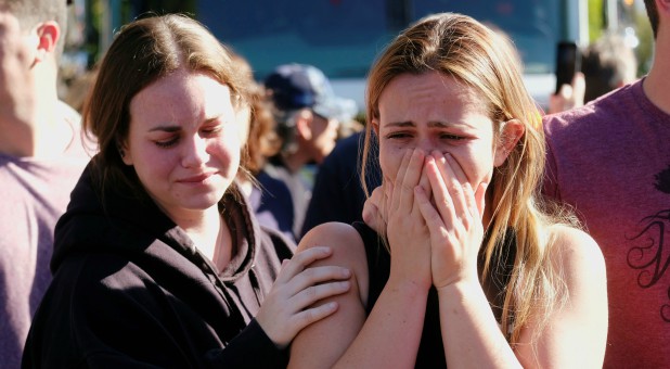 People attend the procession for the Ventura County Sheriff Sgt. Ron Helus, who was shot and killed in a mass shooting at a bar in Thousand Oaks, California.