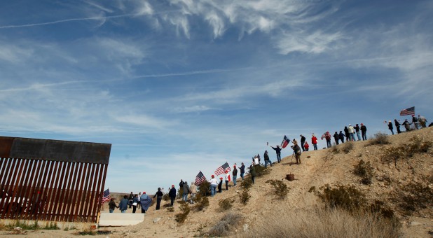 U.S. demonstrators holding U.S. flags gather at the open border to make a human wall in support of the construction of the new border wall between U.S. and Mexico, in Ciudad Juarez, Mexico.