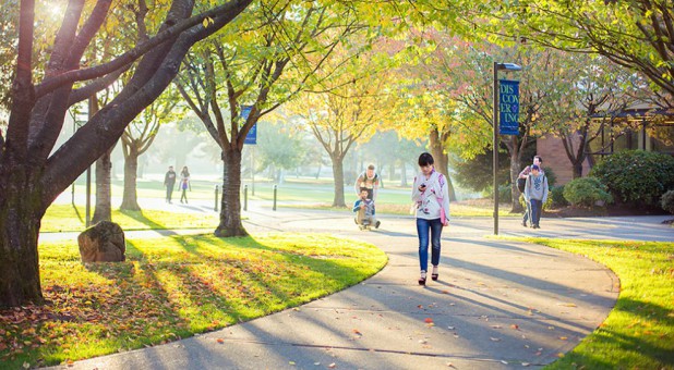 Late-day sun illuminates people on the Trinity Western University campus in Langley, British Columbia.
