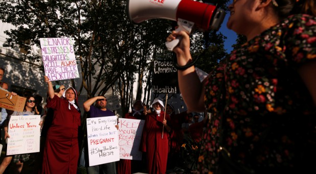 Pro-choice supporters protest in front of the Alabama State House as Alabama state Senate votes on the strictest anti-abortion bill in the United States.