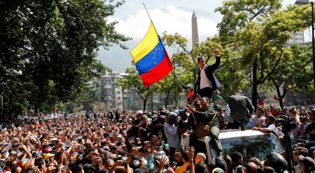 Venezuelan opposition leader Juan Guaido, whom many nations have recognized as the country's rightful interim ruler, gestures after talking to supporters in Caracas, Venezuela.