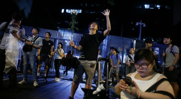 Faithful sing religious songs outside the Legislative Council building as they protest a proposed extradition bill with China in Hong Kong.