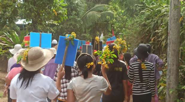 Demonstrators march as they protest against the military coup, in Launglon township, Myanmar.