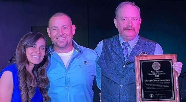 Pastor Caleb Cooper and his wife, Erica, with Sheriff Glenn Hamilton