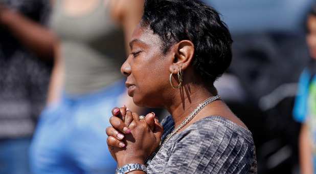 Mourners gather at the scene the day after a shooting at TOPS supermarket in Buffalo, New York, U.S. May 15, 2022.
