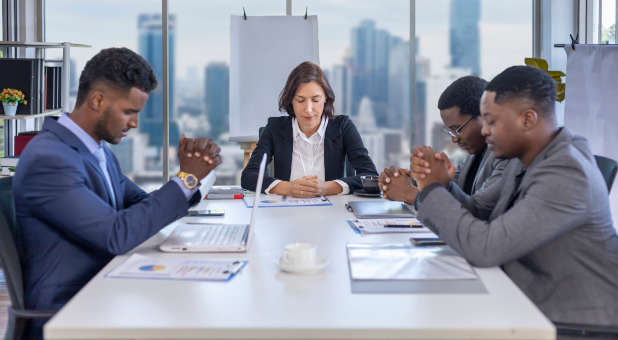 Christian business leaders praying.