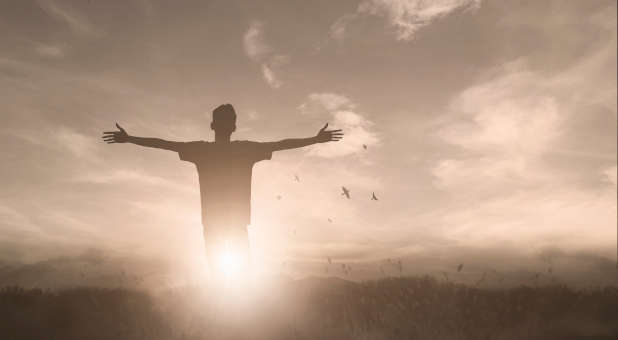 Christian praising God in the sunlight.